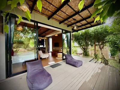 a patio with purple chairs on a wooden deck at Awana Villa Resort Yaonoi - SHA Extra Plus in Ko Yao Noi