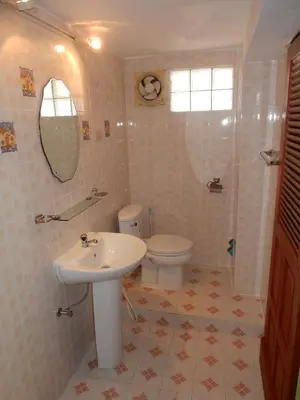 a bathroom with a sink and a toilet and a mirror at Chez Charly Bungalow in Nai Yang Beach