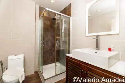 a bathroom with a shower and a sink and a toilet at KB Apartments Karon Beach by PHR in Karon Beach