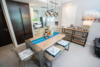 a kitchen with a dining room table and chairs at Karon Sea View Beach Apartment in Karon Beach