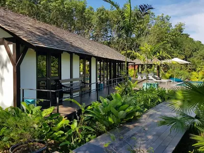 a resort with a garden and a patio at Koyao Bay Pavilions - Beach Resort and Pool Villas in Ko Yao Noi
