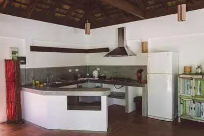 a kitchen with a sink and a refrigerator at Koyao Bay Pavilions - Beach Resort and Pool Villas in Ko Yao Noi