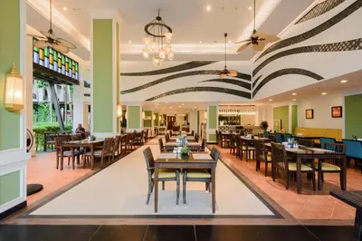 a dining room with tables and chairs in a restaurant at Centara Anda Dhevi Resort & Spa Krabi in Ao Nang Beach