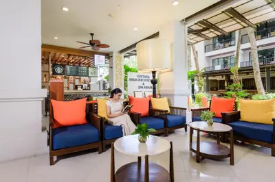 a woman sitting in the lobby of a hotel at Centara Anda Dhevi Resort & Spa Krabi in Ao Nang Beach