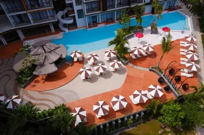 an overhead view of a pool with tables and umbrellas at Sea Seeker Krabi Resort in Ao Nang Beach