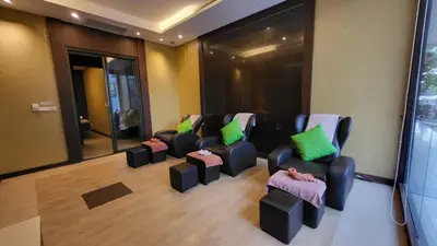 a waiting room with chairs with green and pink pillows at ASHLEE Plaza Patong Hotel & Spa in Patong Beach
