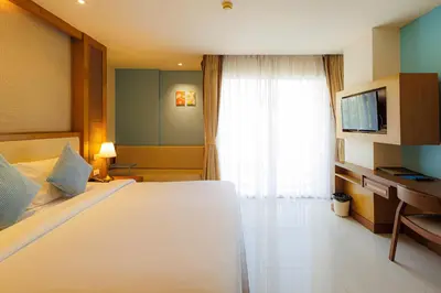 a bedroom with a large white bed and a window at ASHLEE Plaza Patong Hotel & Spa in Patong Beach