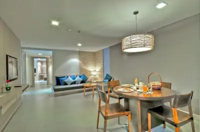 a dining room and living room with a table and chairs at ASHLEE Heights Hotel Patong in Patong Beach