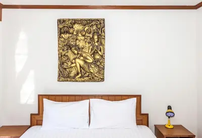 a bedroom with a bed with a painting on the wall at Andaman Sea Patong in Patong Beach