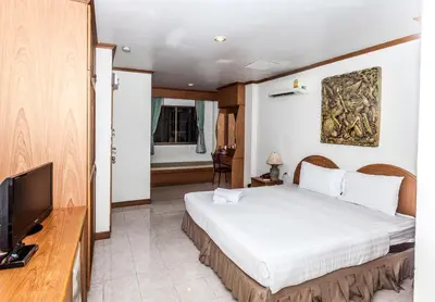 a bedroom with a bed and a flat screen tv at Andaman Sea Patong in Patong Beach