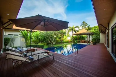 a patio with an umbrella and a swimming pool at VILLA Atarata Private Pool Nai Harn Beach in Rawai Beach