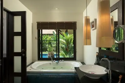 a bathroom with a tub and a sink and a window at VILLA Atarata Private Pool Nai Harn Beach in Rawai Beach