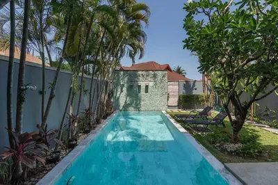a swimming pool in the backyard of a villa with palm trees at VILLA AWA Private Pool Naiharn beach in Rawai Beach