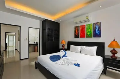 a bedroom with a bed with a swan on it at VILLA Emauha Pool Thaimond Residence Naiharn in Rawai Beach