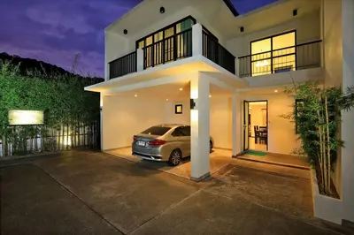 a car parked in the driveway of a house at VILLA Emiemi Pool Thaimond Residence Naiharn in Rawai Beach
