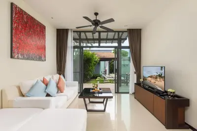 a living room with a white couch and a ceiling fan at Villa Hahana Private Pool Near Nai Harn Beach in Rawai Beach