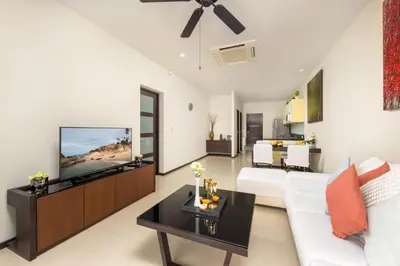 a living room with a couch and a tv at Villa Hahana Private Pool Near Nai Harn Beach in Rawai Beach