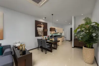 a living room with a couch and a table and a kitchen at VILLA Iotama Private Pool Nai Harn Beach in Rawai Beach