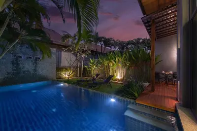 a villa with a swimming pool at night at VILLA Iotama Private Pool Nai Harn Beach in Rawai Beach