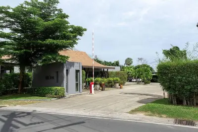 a building with a red fire hydrant next to a street at VILLA JAVA Private Pool Nai Harn Beach in Rawai Beach