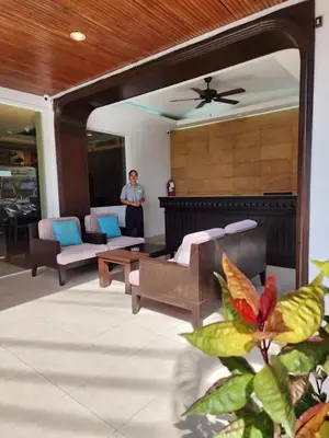 a man standing in the living room of a house at Sunset Mansion in Patong Beach