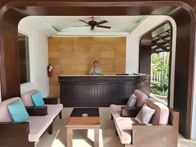 a woman standing behind a bar in a room at Sunset Mansion in Patong Beach