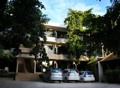 three cars parked in front of a building at Baan Pron Phateep in Patong Beach