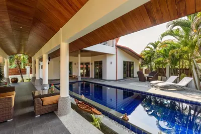 an outdoor living area with a swimming pool and a house at Amber Pool Villa Your private slice of paradise in Rawai Beach