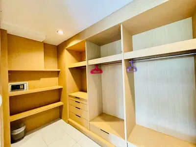 a walk in closet with wooden shelves and a window at Good Nice Hotel in Patong Beach
