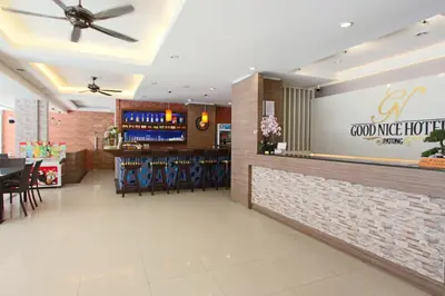 a restaurant with a bar with blue chairs at Good Nice Hotel in Patong Beach