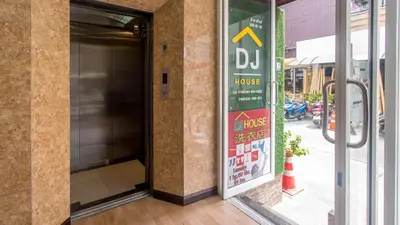 an open door to a house with a sign on it at DJ House ดีเจ เฮ้าท์ป่าตอง in Patong Beach