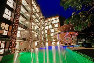 a swimming pool in the middle of a building at Emerald Terrace Patong in Patong Beach