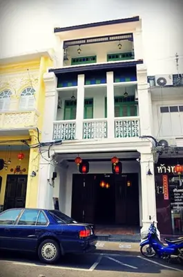 a blue car parked in front of a building at 99 Oldtown Boutique Guesthouse SHA EXTRA PLUS in Phuket Town