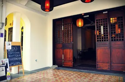 an entrance to a building with wooden doors at 99 Oldtown Boutique Guesthouse SHA EXTRA PLUS in Phuket Town