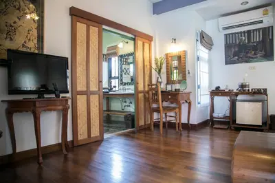 a living room with a television and a table at West Key Kamala Villa in Kamala Beach