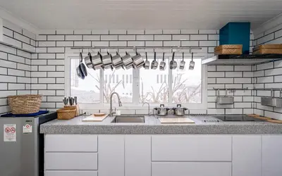 a kitchen with a sink and a window at The Color Kata in Kata Beach