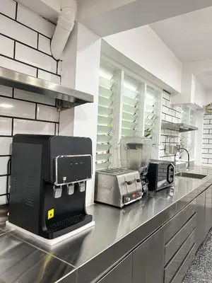 a kitchen with a counter top with a appliance on it at The Color Kata in Kata Beach