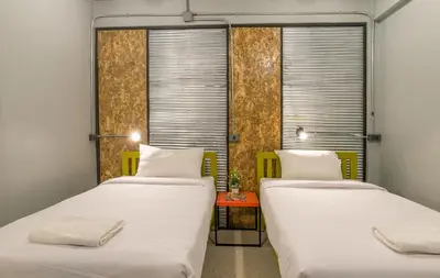 two beds in a room with two windows at Sanim Hostel in Ao Nang Beach