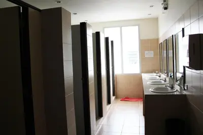 a bathroom with three sinks and a row of mirrors at Lub Sbuy Hostel in Phuket Town