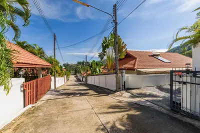 an empty street in front of a house at Aster Pool Villa Your Tropical Villa In Paradise in Rawai Beach