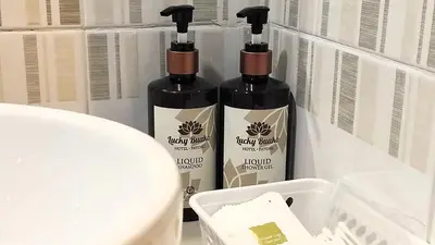 two bottles of lotion sitting on top of a counter at Lucky Buako Hotel Patong in Patong Beach