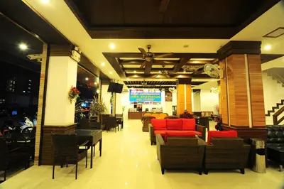 a restaurant with red chairs and tables and a ceiling at Arita Hotel Patong in Patong Beach