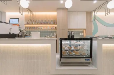 a bakery with a display case of donuts at Baan Sutra Guesthouse in Phuket Town