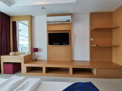a hotel room with a tv and a bed at Le Desir Resortel in Chalong