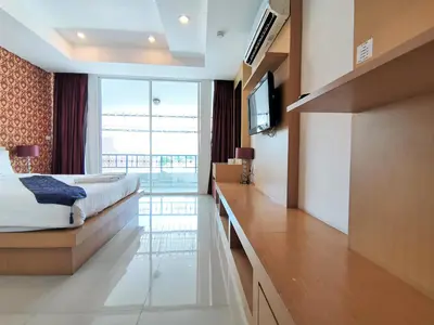 a hotel room with a bed and a television at Le Desir Resortel in Chalong