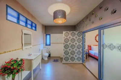 a bathroom with a sink and a toilet in a room at Perennial Resort in Nai Yang Beach