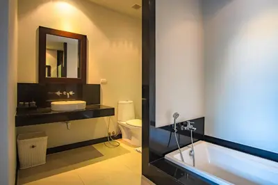 a bathroom with a tub and a sink and a toilet at ONYX Villa Naiharn - 1 Bedroom with private pool in Nai Harn Beach