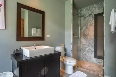 a bathroom with a sink and a toilet and a shower at ONYX Villa Naiharn - 3 Bedrooms with private pool in Nai Harn Beach