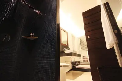 a black bathroom with a toilet and a sink at Villa 3 Bedrooms with private pool at Oxygen Bangtao in Bang Tao Beach