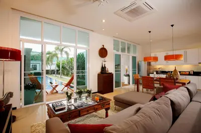 a living room with a couch and a table at Villa 4 Bedrooms with private pool at Oxygen Bangtao in Bang Tao Beach